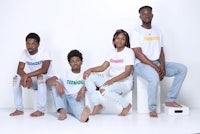 a group of people posing for a photo in front of a white background